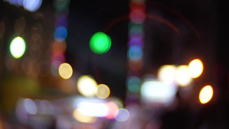 the movement of unrecognizable pedestrians walking through the city at night. Street background. blur.の写真素材