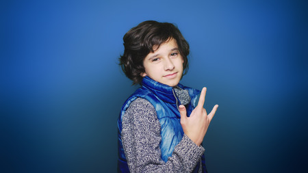 Back to school. Portrait of a teen boy who poses for the camera in autumn clothes. Education.の写真素材