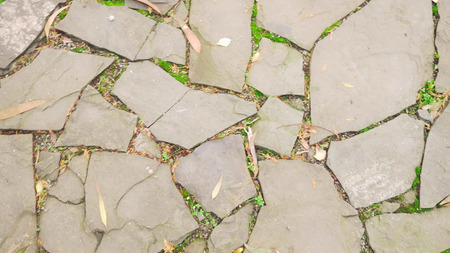 Texture of separate stones on the ground. paved walkway.