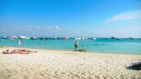 abstract blur background of beach on island , resting people and boatsの写真素材