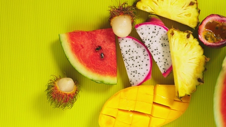 tropical fruits on a bright yellow background. Minimal fruit concept. copy spaceの写真素材