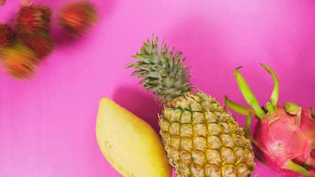 tropical fruit on a bright pink background. Minimal fruit concept.の写真素材
