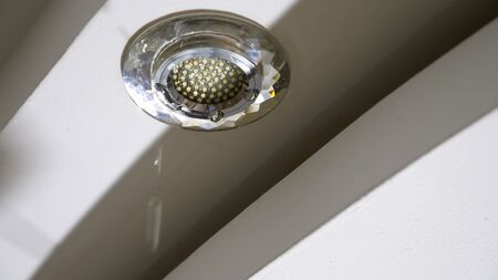 concept of flood in apartment and property insurance. Water passes through electric ceiling lights...