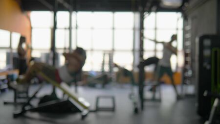 blurred background. people involved in sports in the gym for fitness, interior of new modern equipment, sport conceptの写真素材