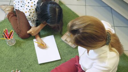 female psychologist conducts diagnostics for teenage girl, projective drawing method. back to school, learning problems conceptの写真素材