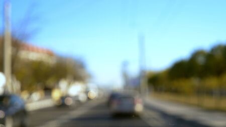 blurred background. Cars drive along the highway on a city bypass on a clear summer day. copy space. blue skyの写真素材