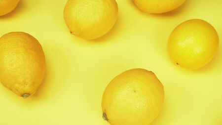 fruit background. ripe lemons on a yellow background. fashion design