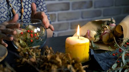 pagan ritual magic. a potion of herbs. the woman is a witch preparing herbalの写真素材