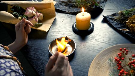 runic magic. master burns runic spell on parchment