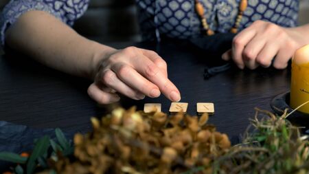 female white magician predicts the future by runes. runic magicの写真素材