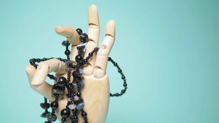 black agate beads on a wooden arm. blue backgroundの写真素材