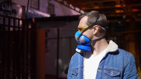 man in respirator outdoors on a clear Sunny day. closeup. portraitの写真素材