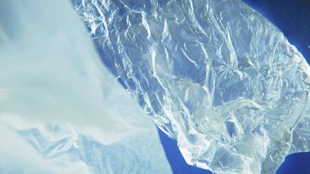 plastic bag and tissue paper floating under water. copy spaceの写真素材
