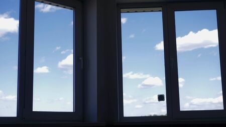 the view from the apartment window at the blue sky with white clouds