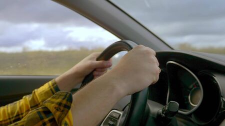 closeup. hands of a man driving a car while driving