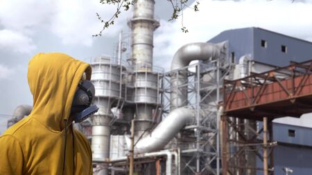 man in respirator against the background of factory chimneysの写真素材