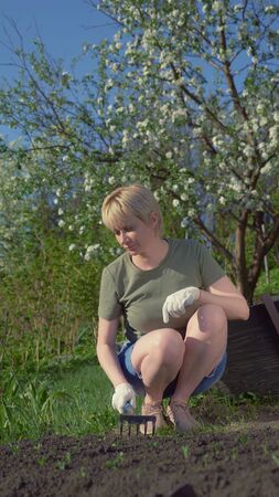 vertically. young beautiful woman loose the beds in the garden. copy spaceの写真素材