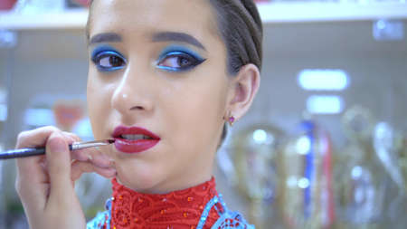 close-up. portrait of a beautiful girl model. makeup artist makes bright makeupの写真素材