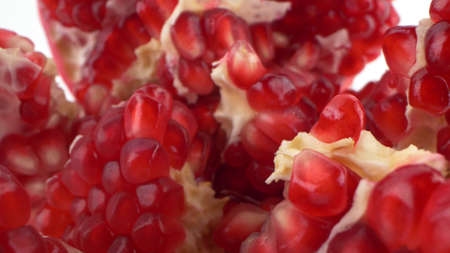 detailed disclosed pomegranate with ripe seeds isolated white backgroundの写真素材