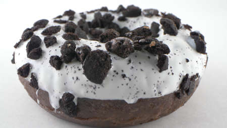 Close-up, detailed. donut with white icing and chocolate chips. White backgroundの写真素材