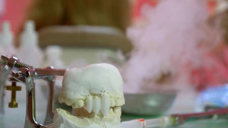 extreme close-up, mock up of human jaw with teeth and dental tools