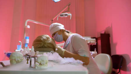 blurred background. dentist tools in smoke on the background of a working dentist