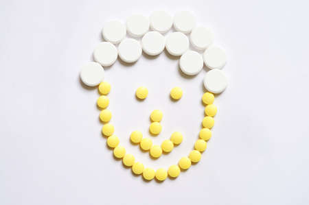 Smile face made of tabletsの写真素材