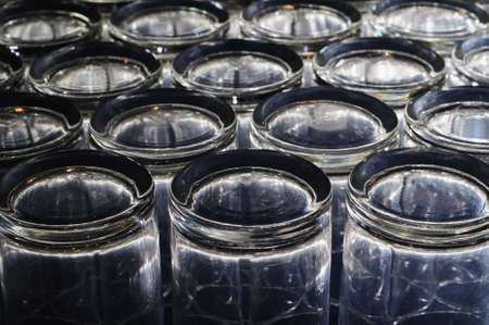 glowing glass bottom arranged in rowsの写真素材