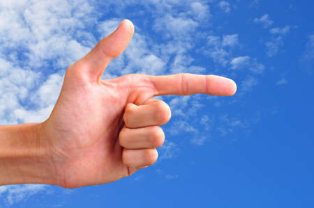 hand pointing in blue skyの写真素材