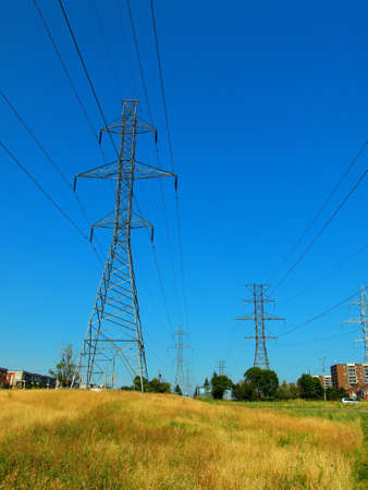 Electric post in a field and blue skyの写真素材