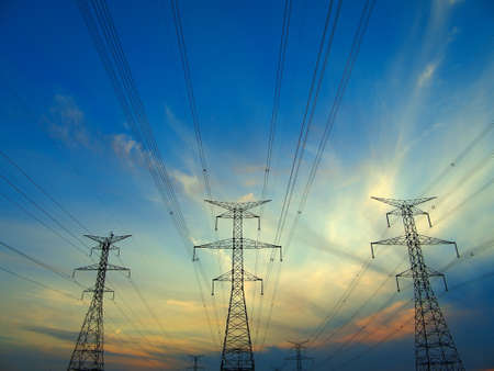 Electric post in a field and blue skyの写真素材