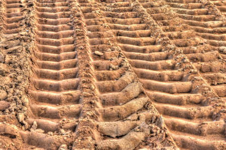 lots of deep truck tracks on the sandの写真素材