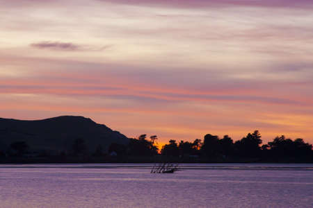 a brilliant colourful sunset with purple and orange coloursの写真素材