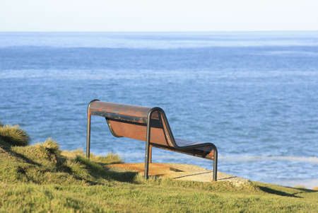 a old steel bench overlooking the ocean