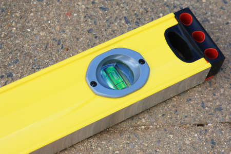 an end view of yellow spirit level on the bricks