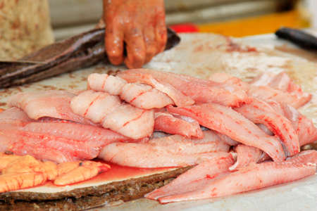 a man filleting freshly caught fish