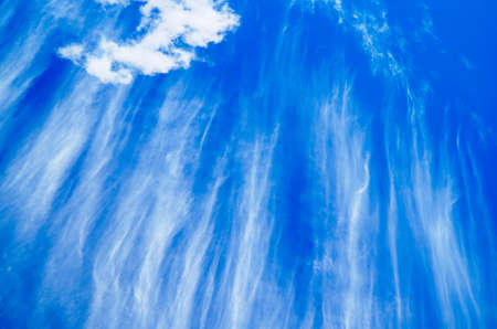 white striking clouds with bright blue sky