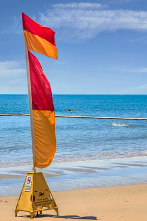 one life saving warning sign flag on the beachの写真素材
