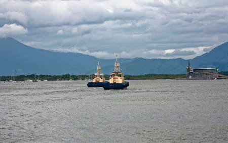 two tug boats coming into Cairns Port