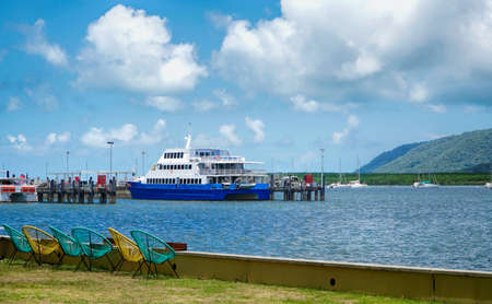 Cairns foreshore Queensland Australia. Overlooking Trinity inlet with colorful deck chairsの写真素材