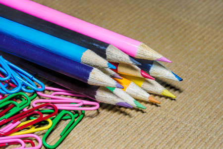 a lot of colorful penciles set in a row with  paper clipsの写真素材