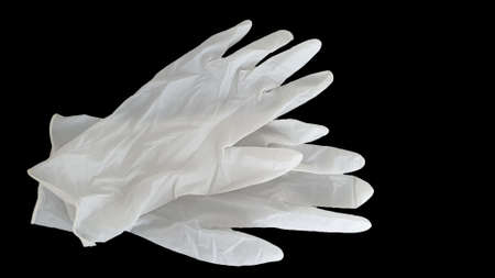 white disposable gloves on a black background