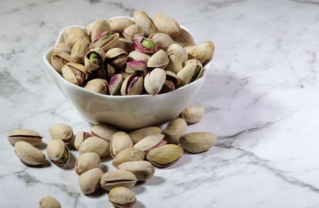 small bowl of pistachio nuts on the benchの写真素材