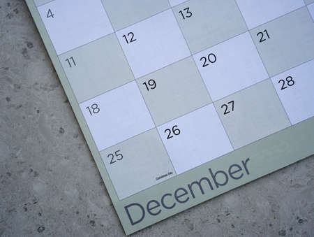 a closeup of a desktop calender with a black pen