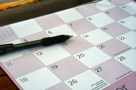 a closeup of a desktop calender with a black penの写真素材
