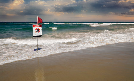 warning sign do not swim in water. Beautiful blue water an surf with blue sky