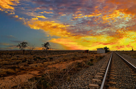 Beautiful Sunrise over a Vast Outback Australia with Railroad Tracks. Vast desolate countryside.