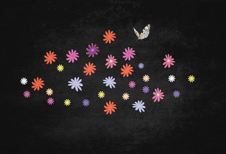 pretty flowers scattered on the page with a butterfly perched above, background is a grungy black effectの写真素材