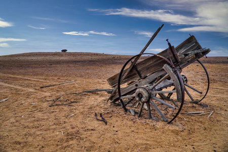 A desolate landscape featuring an abandoned cart in Out back South Australiaの写真素材