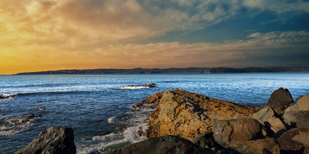 Quarantine Bay Eden New South Wales a tranquil scene at sunset , calm water, and a warm orange sky . Ideal for travel, nature, or nautical themes and peaceful ambiance.の写真素材